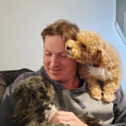 Daniel Westfall with his dogs in a relaxed outdoor setting